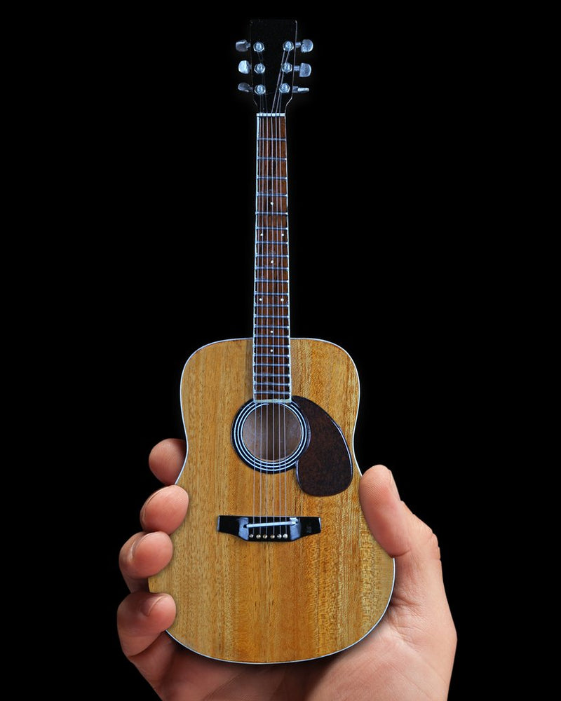 Classic Natural Finish Acoustic Miniature Guitar Replica Collectible  This collectible miniature guitar replica was handcrafted out of solid wood. The back has a rich rosewood stain and stunning detail. This is a great replica of a classic natural finish standard acoustic. in hand