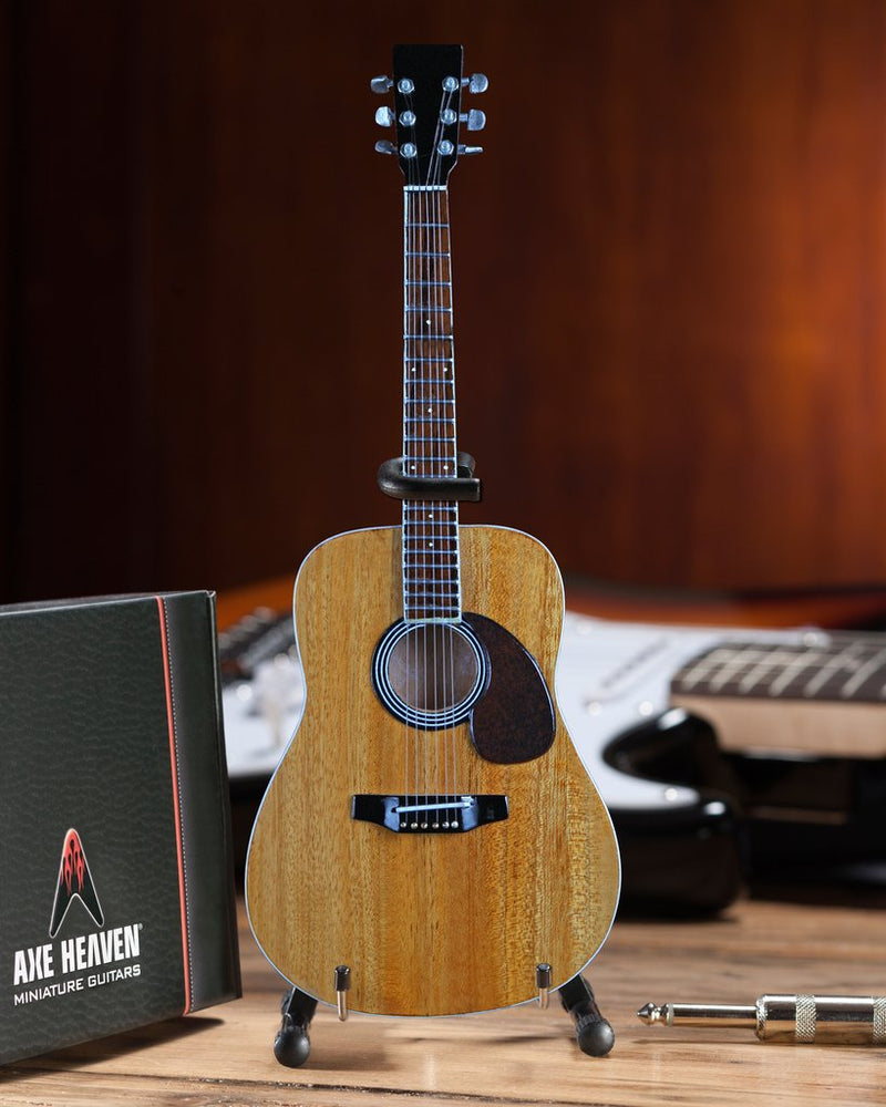 Classic Natural Finish Acoustic Miniature Guitar Replica Collectible  This collectible miniature guitar replica was handcrafted out of solid wood. The back has a rich rosewood stain and stunning detail. This is a great replica of a classic natural finish standard acoustic. on desk