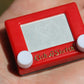 World’s Smallest Etch A Sketch in hand