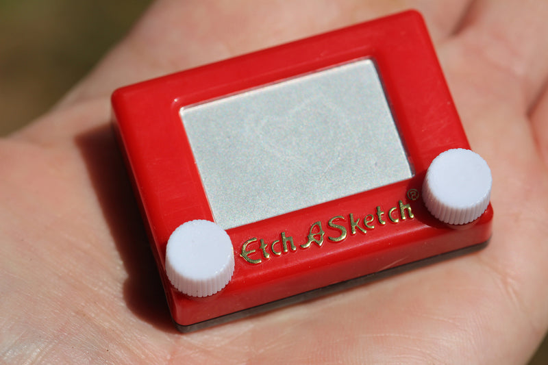 World’s Smallest Etch A Sketch in hand